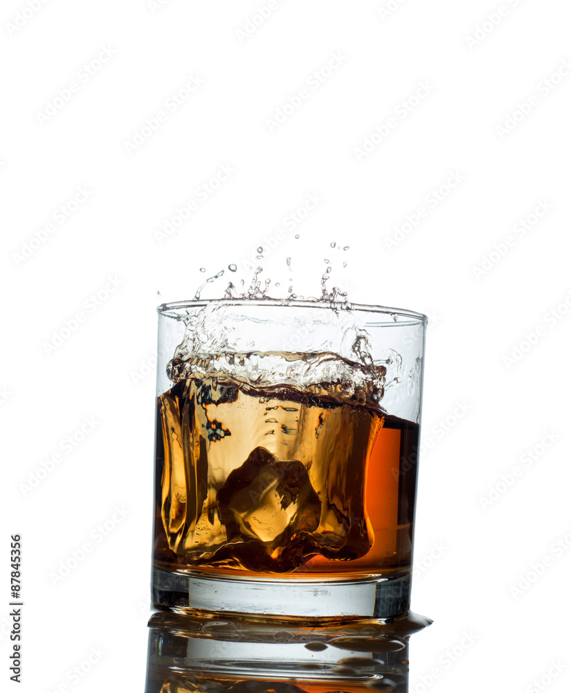 splash of whiskey with ice osolated on white splash of whiskey with ice osolated on white