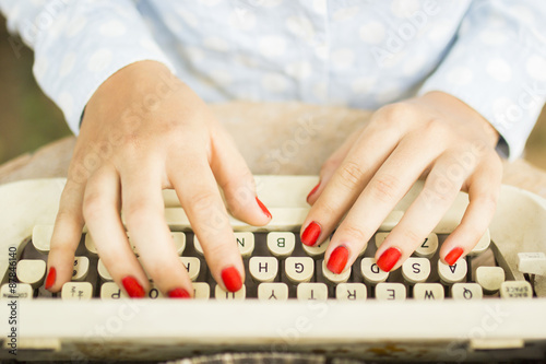 woman typing on a typewriter