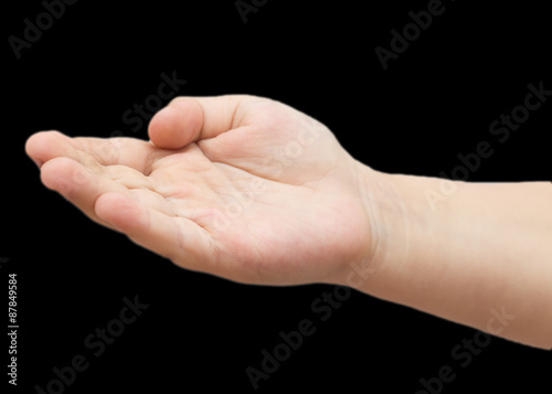 child's hand on a black background