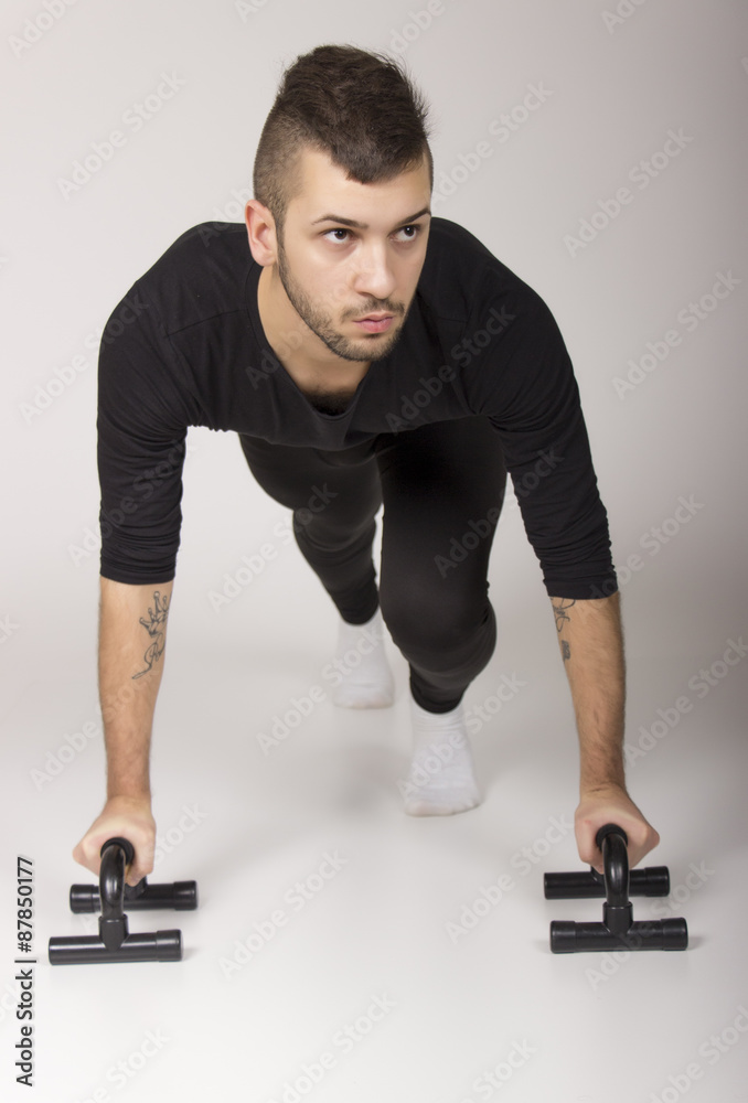 Dancer exercising push ups, on white background. Dancer exercising push ups, on white background.
