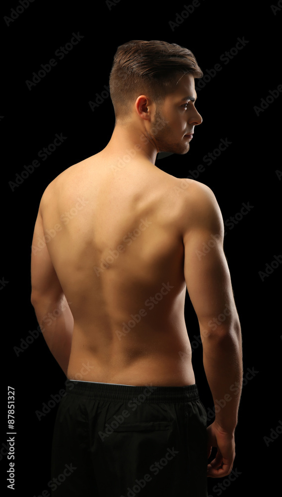 Fototapeta premium Muscle young man on dark background