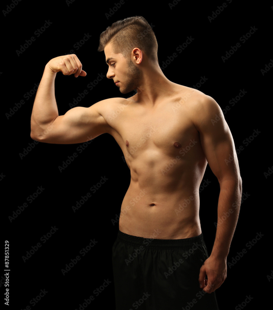 Muscle young man on dark background Muscle young man on dark background