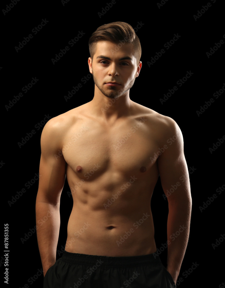 Fototapeta premium Muscle young man on dark background