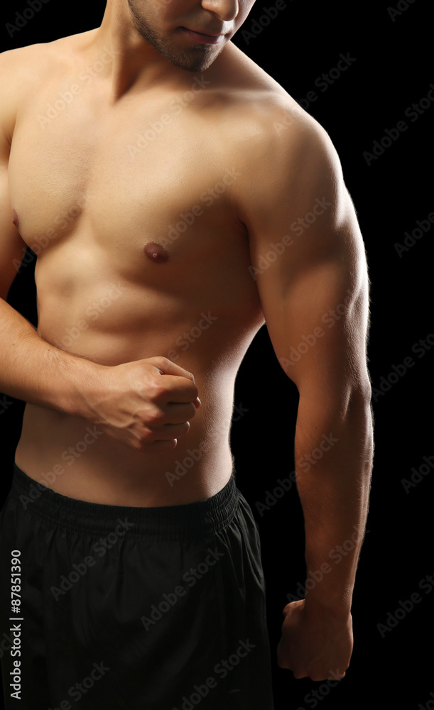 Muscle young man on dark background