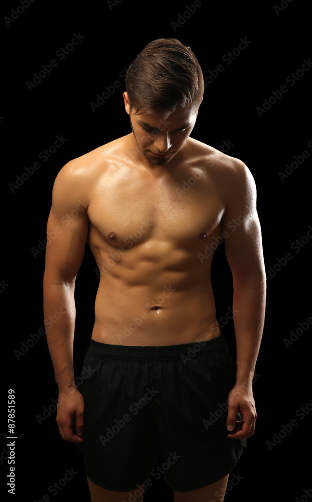 Muscle young man on dark background