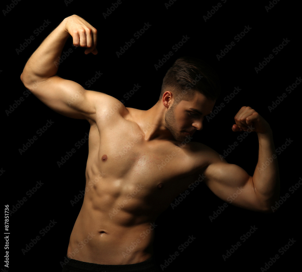 Muscle young man on dark background Muscle young man on dark background