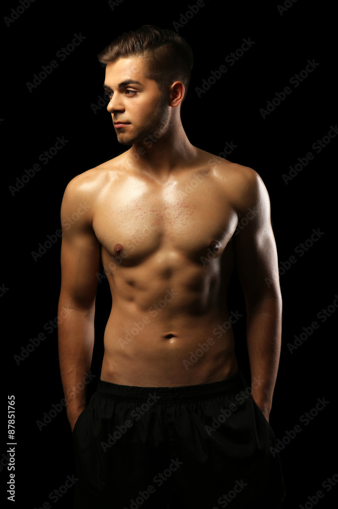 Muscle young man on dark background