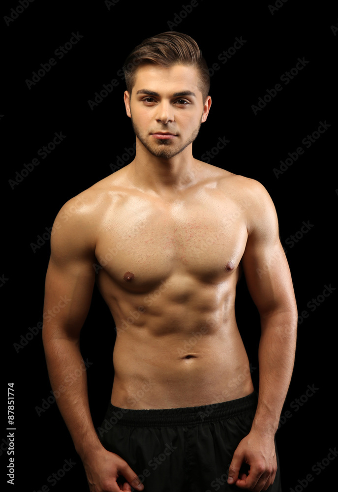 Muscle young man on dark background Muscle young man on dark background