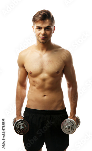 Muscle young man holding dumbbells isolated on white © Africa Studio
