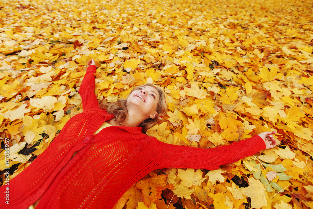Woman laying on autumn leaves Woman laying on autumn leaves
