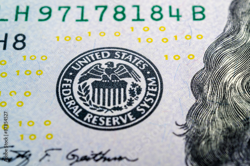 Federal reserve system symbol on hundred dollar bill closeup mac