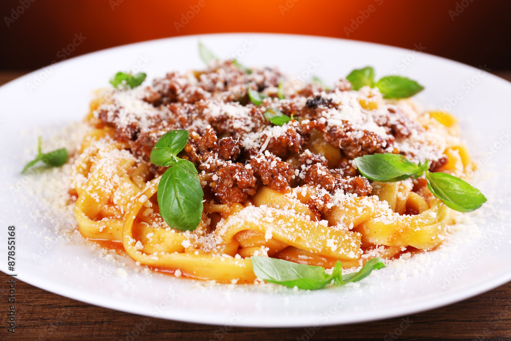 Pasta Bolognese with parmesan and basil on table close up Pasta Bolognese with parmesan and basil on table close up