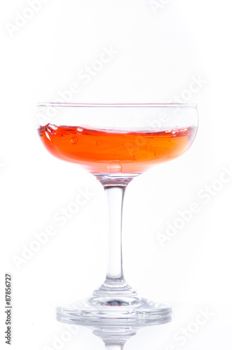 orange cocktail in glass isolated on white background