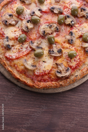 Tasty pizza with vegetables on wooden background