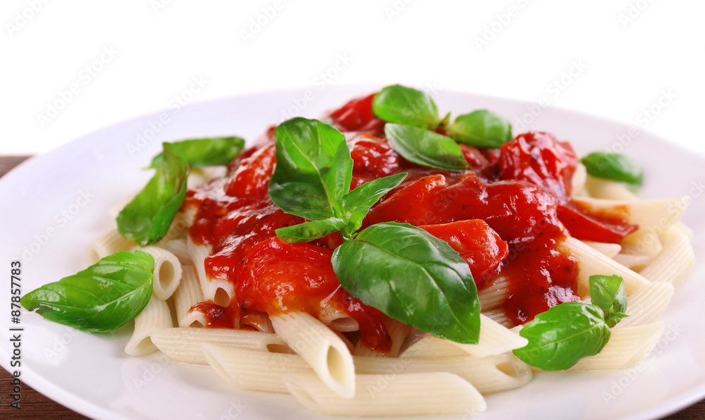 Pasta with tomato sauce and basil on light background