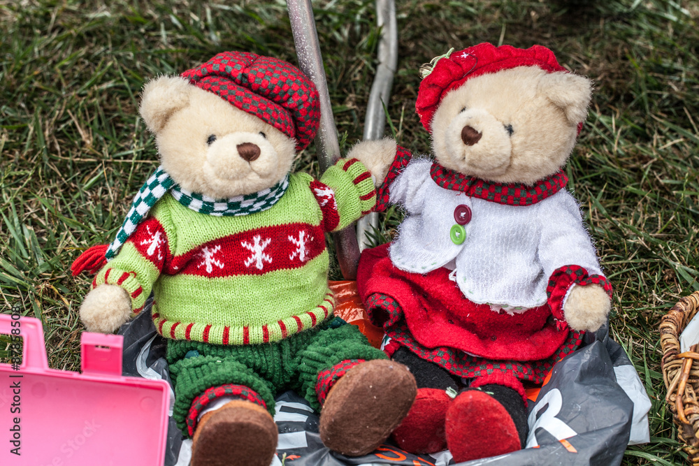 display of a couple of second hand teddy bears dressed up for winter or Christmas time with home made knitwear sold at garage sale for antique collection Stock Photo Adobe Stock