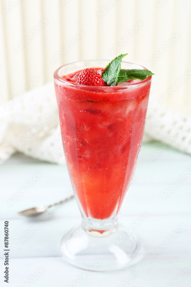 Strawberry dessert with ice in glass, on wooden table, on light background Strawberry dessert with ice in glass, on wooden table, on light background