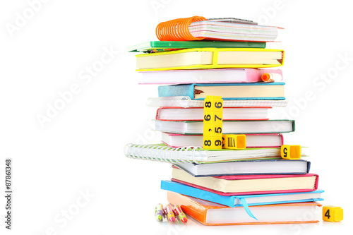 Stack of books and stationery isolated on white