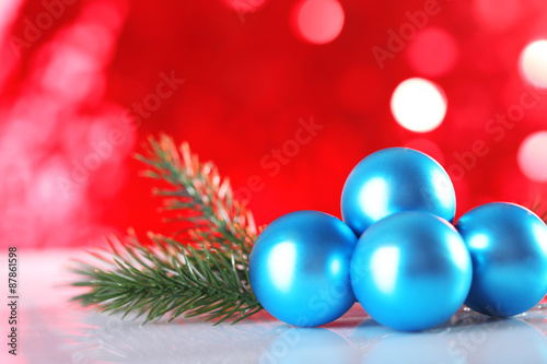 Beautiful Christmas balls on red blurred background