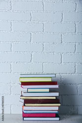 Stack of books on shelf.