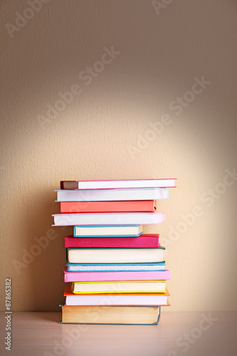 Stack of books on shelf.