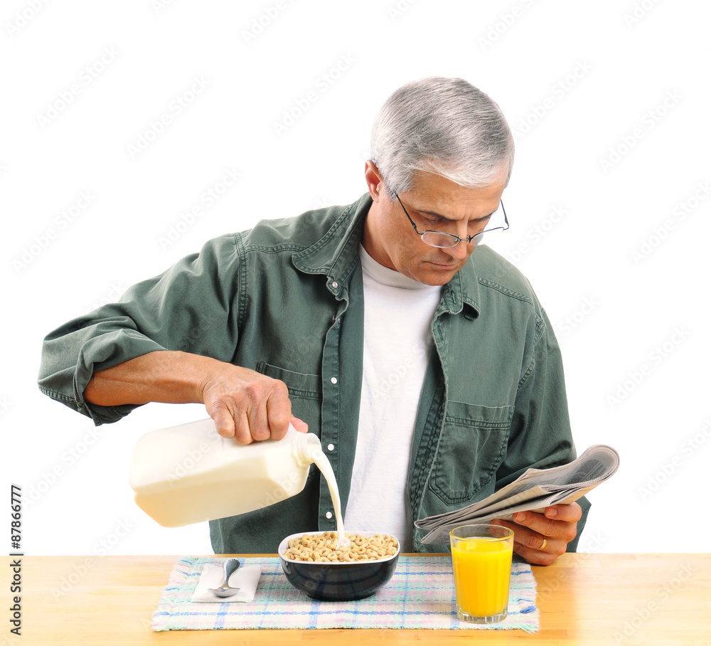 Middle Aged Man Pouring Milk into His Cereal Bowl Stock Photo | Adobe Stock