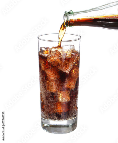 bottle pouring coke in drink glass with ice cubes Isolated on wh