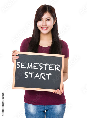 Tableau sur toile Asian woman with chalkboard showing semester start on board