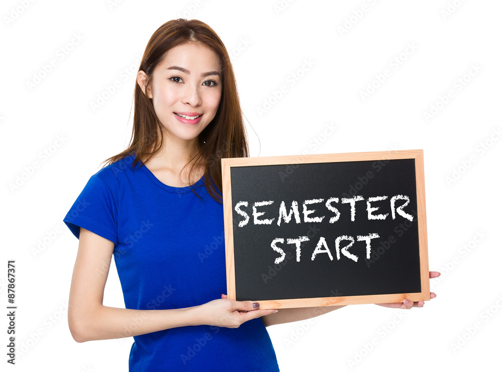 Student hold with wooden chalkboard showing semester start on bo Student hold with wooden chalkboard showing semester start on bo