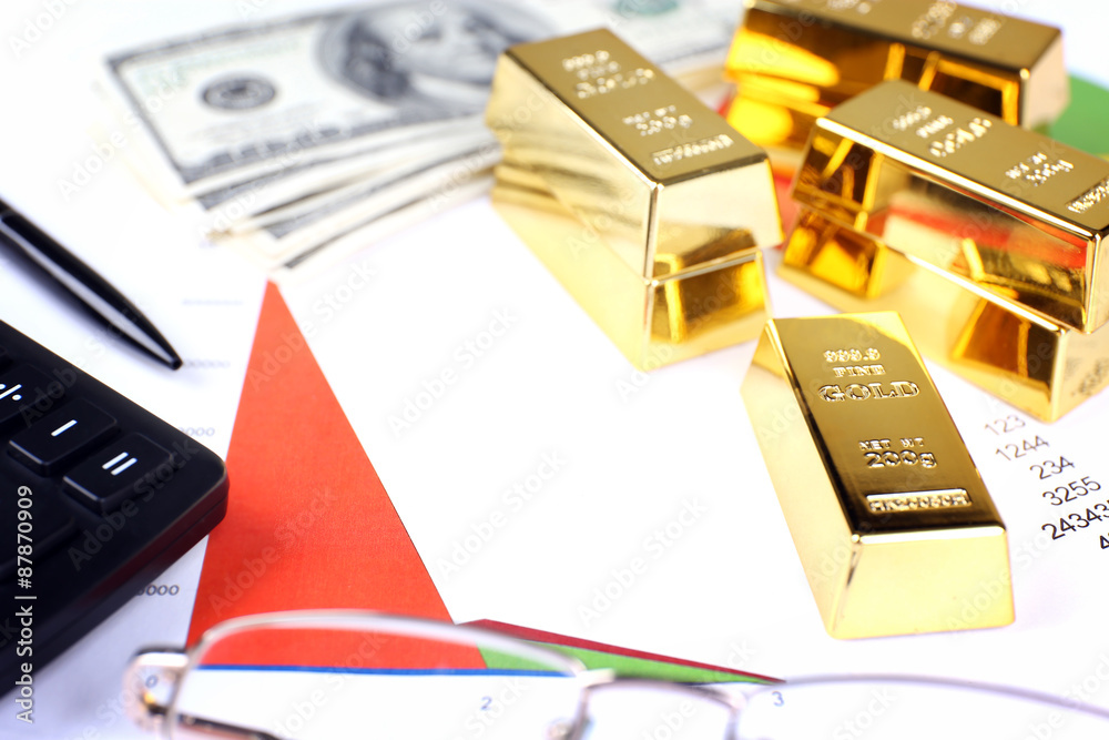 Gold bullion with money on table close up Gold bullion with money on table close up