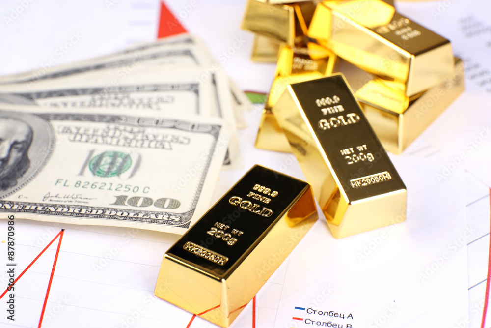 Gold bullion with money on table close up Gold bullion with money on table close up