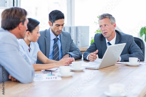 Business people speaking together during meeting 