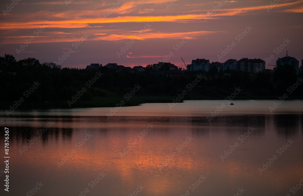 Summertime landscape with sunset over lake