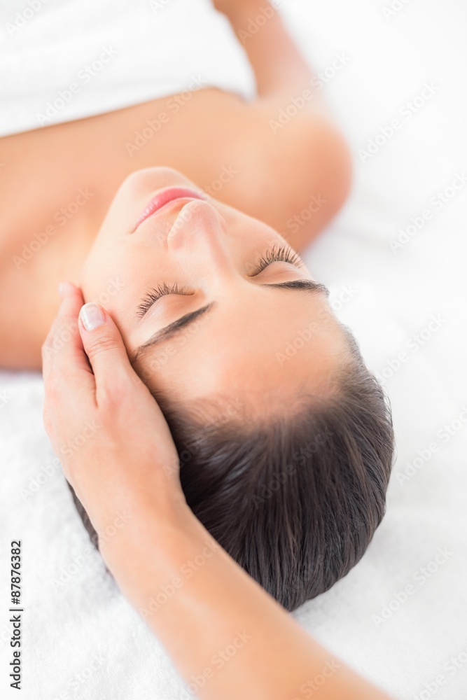 Attractive young woman receiving facial massage at spa center Attractive young woman receiving facial massage at spa center