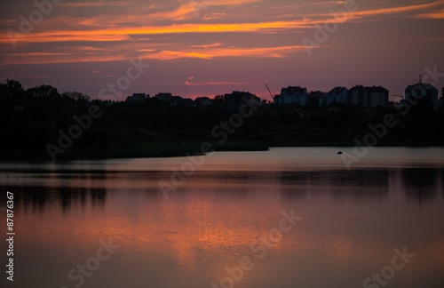 Summertime landscape with sunset over lake