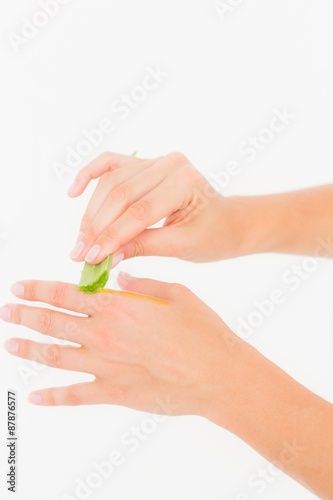 A woman put aloe vera on his hand 