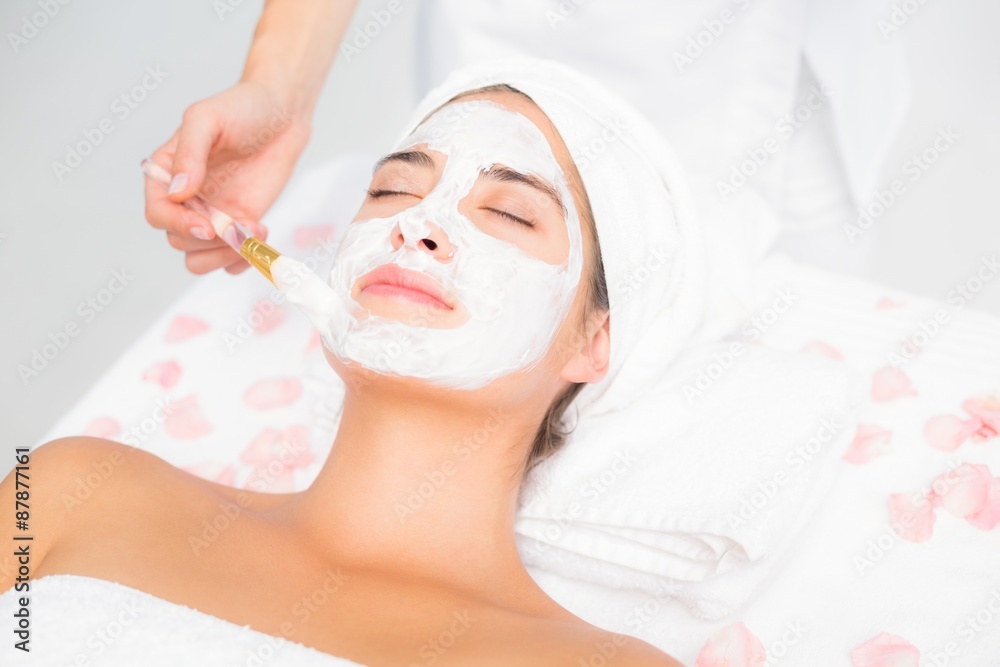 Attractive woman receiving a cream treatment 