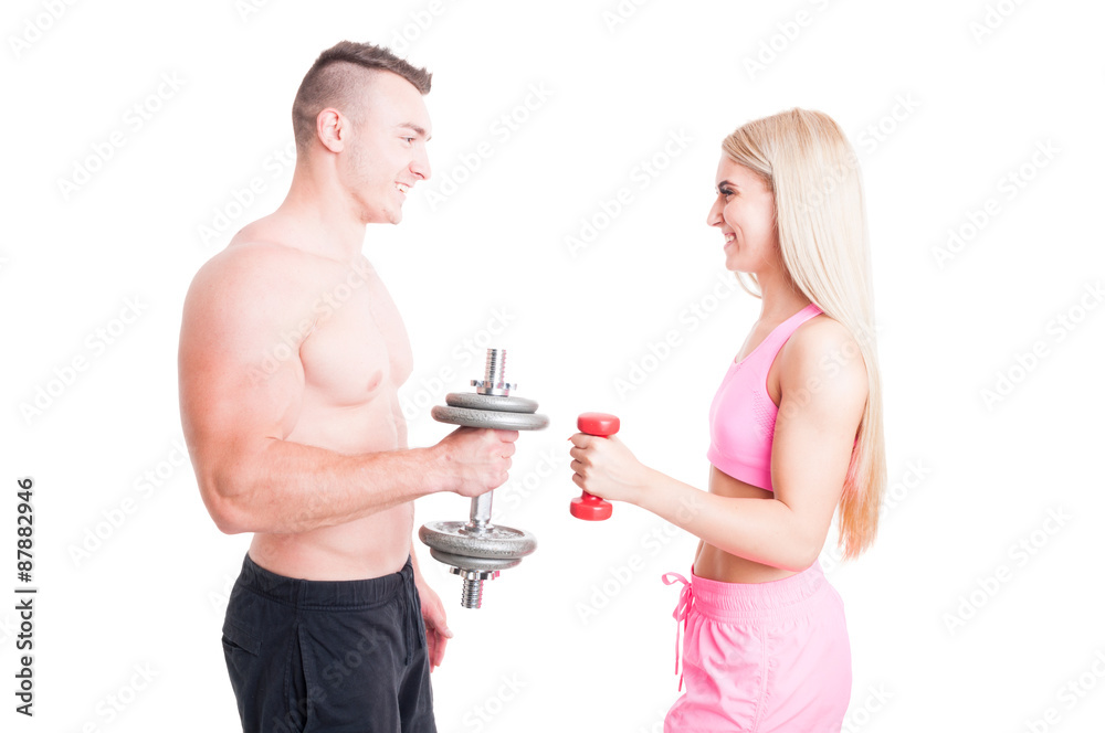 Happy active and sporty couple lifting weights together Happy active and sporty couple lifting weights together