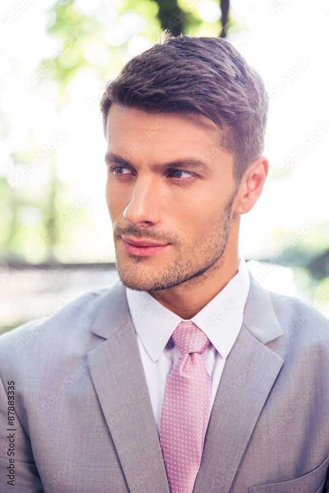 Businessman looking away outdoors Businessman looking away outdoors