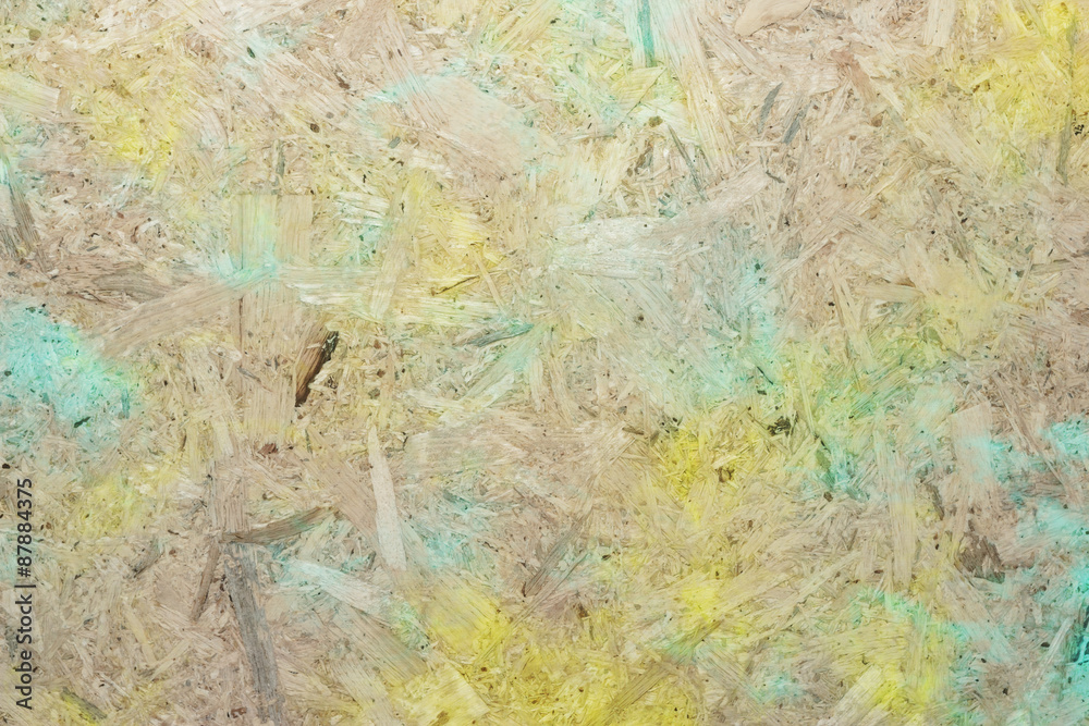 Close-up of pressboard background with green yellow