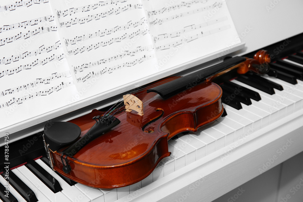 Fototapeta premium Piano with violin and music notes close up