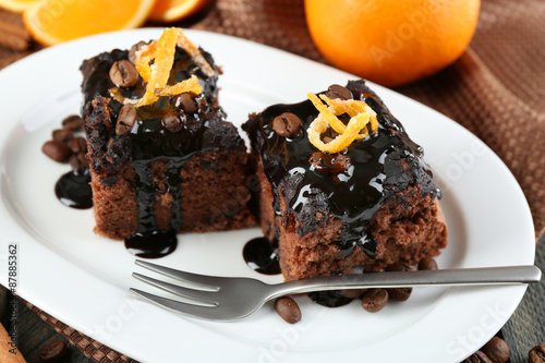 Portion of Cake with Chocolate Glaze and orange on plate, close-up