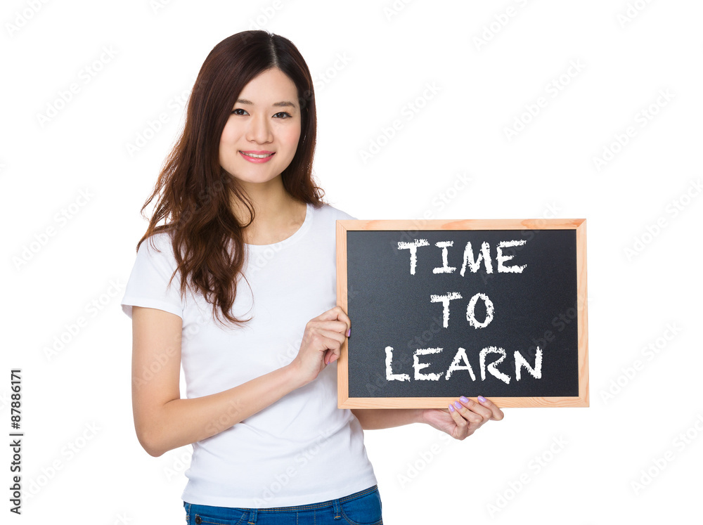 Woman with the chalkboard showing phrase of time to learn Woman with the chalkboard showing phrase of time to learn