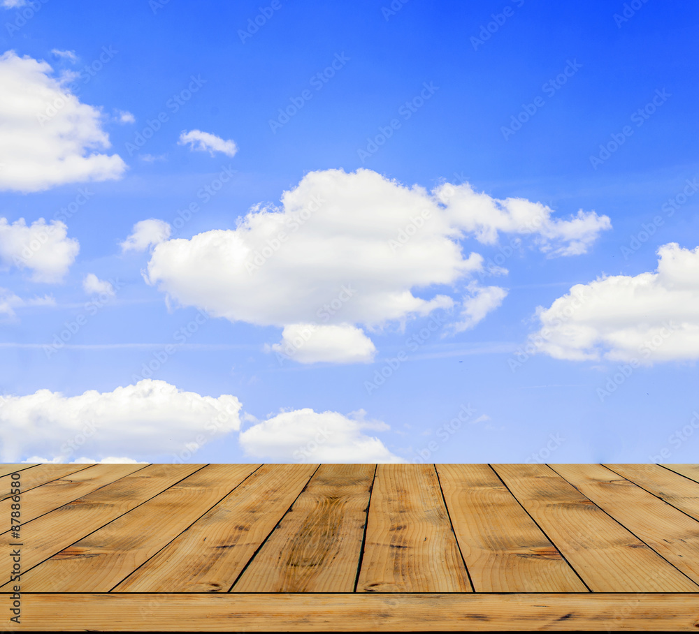 Beautifull blue cloudy sky with wooden table