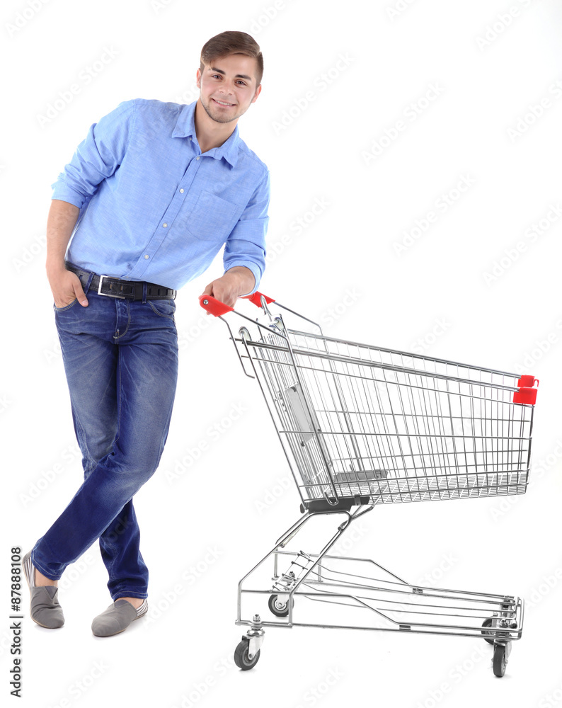 Young man with empty shopping cart, isolated on white Young man with empty shopping cart, isolated on white