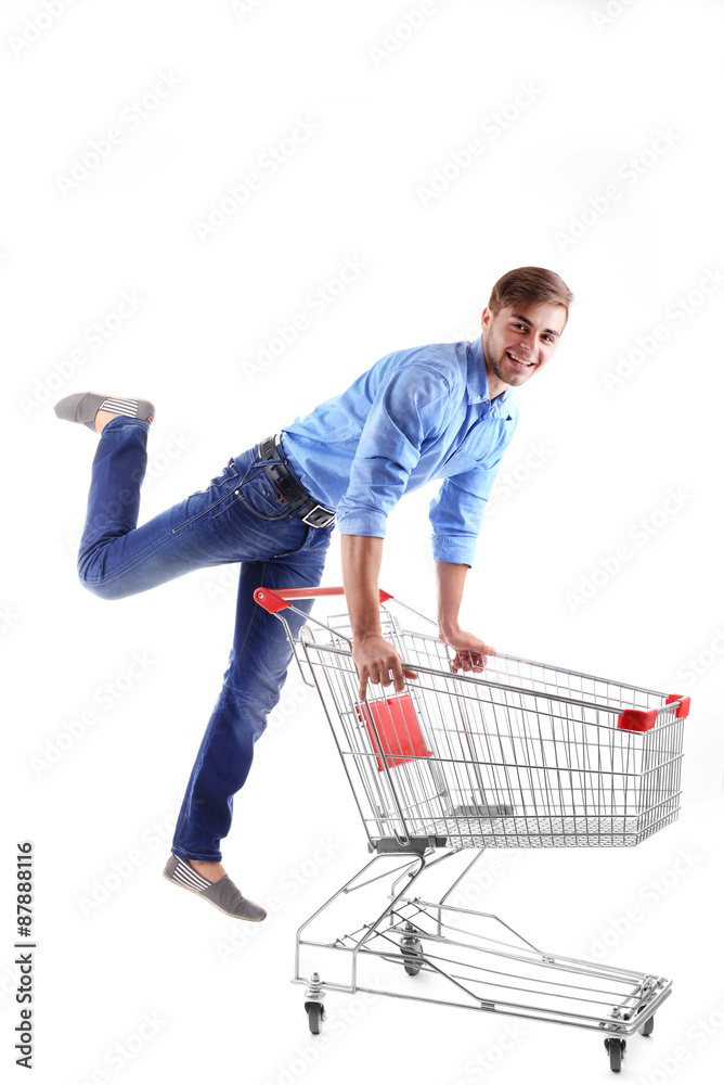 Young man with empty shopping cart, isolated on white Young man with empty shopping cart, isolated on white