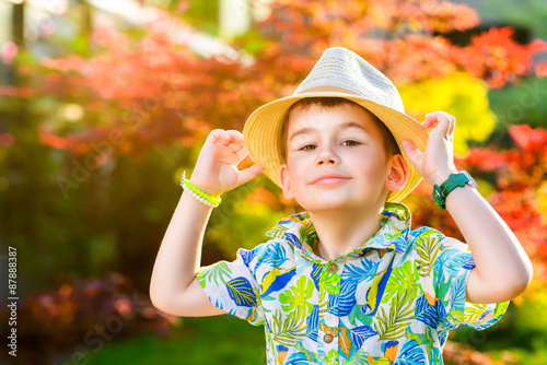 Young traveler in hat over garden background