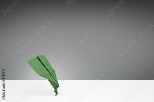 Fotografija Green Paper airplane with a bent nose