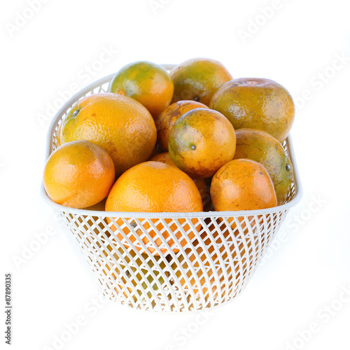 orange fruit in basket, isolated on white background