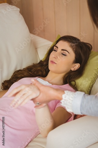 Hypnotherapist holding her patients wrist